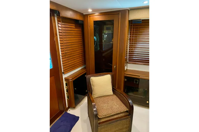 Slide: The Image of 1986 Huckins Sport Fisherman interior with wooden blinds and wicker chair. - 18
