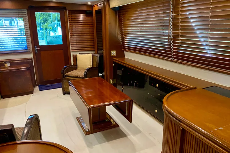 Slide: The Image of Luxurious interior of a 1986 Huckins Sport Fisherman yacht with wooden furnishings and blinds. - 19