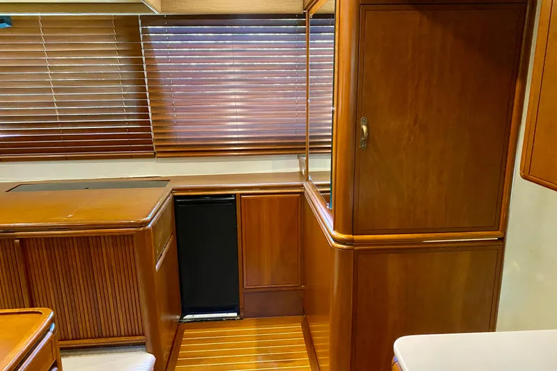 Slide: The Image of Interior of 1986 Huckins Sport Fisherman with wooden cabinetry and blinds. - 21