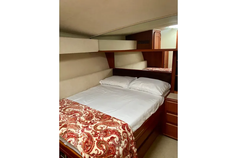 Slide: The Image of Cozy cabin bedroom in 1986 Huckins Sport Fisherman yacht with elegant bedding. - 26