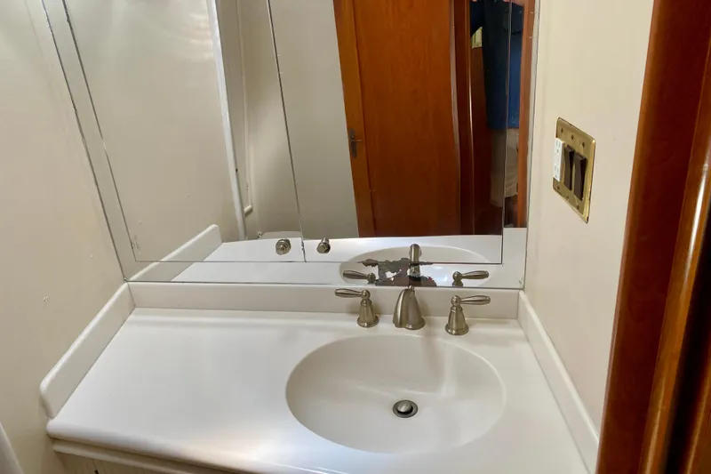 Slide: The Image of Bathroom sink and mirror on a 1986 Huckins Sport Fisherman boat. - 29