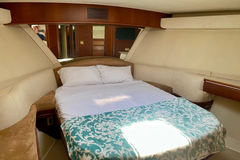 Slide: The Image of Luxurious 1986 Huckins Sport Fisherman cabin with cozy bed and elegant wood accents. - 31