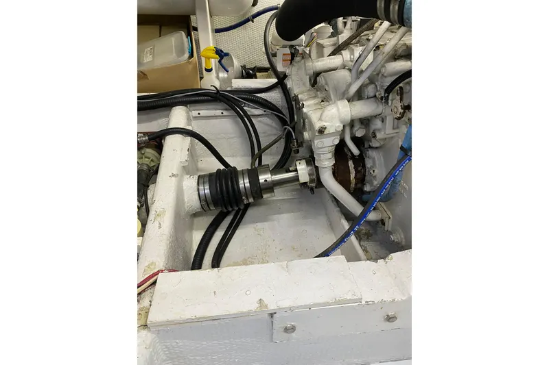 Slide: The Image of Engine compartment of a 1986 Huckins Sport Fisherman boat, showcasing mechanical components. - 35