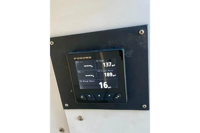Slide: The Image of Furuno display showing fuel, fresh water, and black water levels on 1986 Huckins Sport Fisherman. - 39