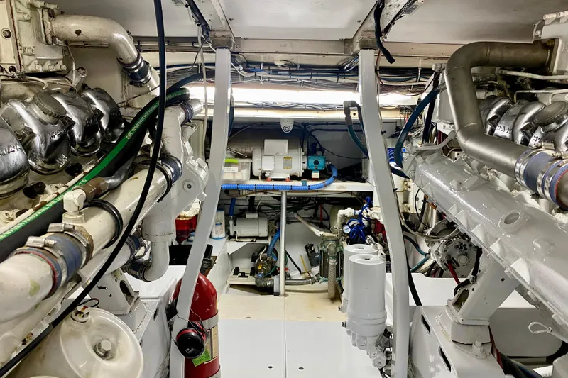Slide: The Image of Engine room of a 1986 Huckins Sport Fisherman boat, showcasing mechanical components. - 40