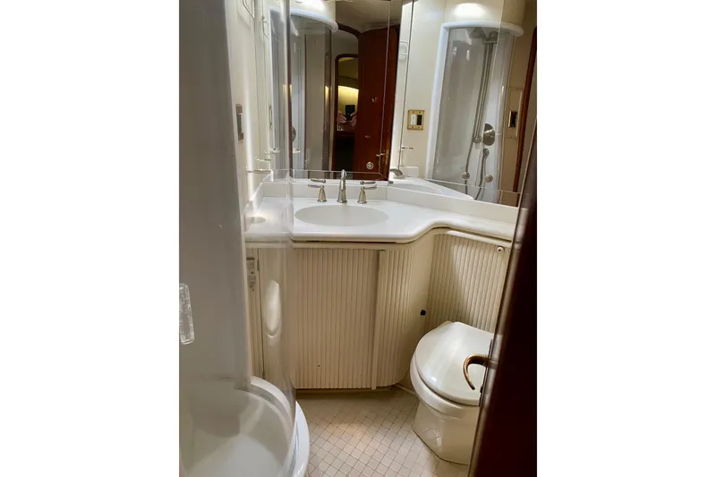 Slide: The Image of Compact bathroom in 1986 Huckins Sport Fisherman yacht with shower, sink, and toilet. - 41