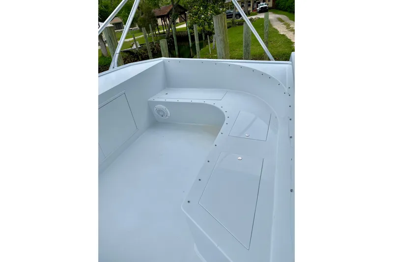 Slide: The Image of 1986 Huckins Sport Fisherman boat deck with storage compartments and speaker. - 7