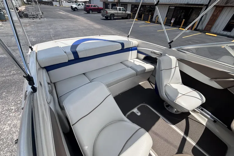 Slide: The Image of Interior of a 2003 Bayliner 185 Capri boat with white seating and blue accents. - 19