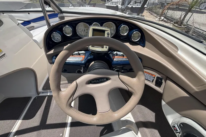 Slide: The Image of 2003 Bayliner 185 Capri dashboard with steering wheel and instrument panel. - 22