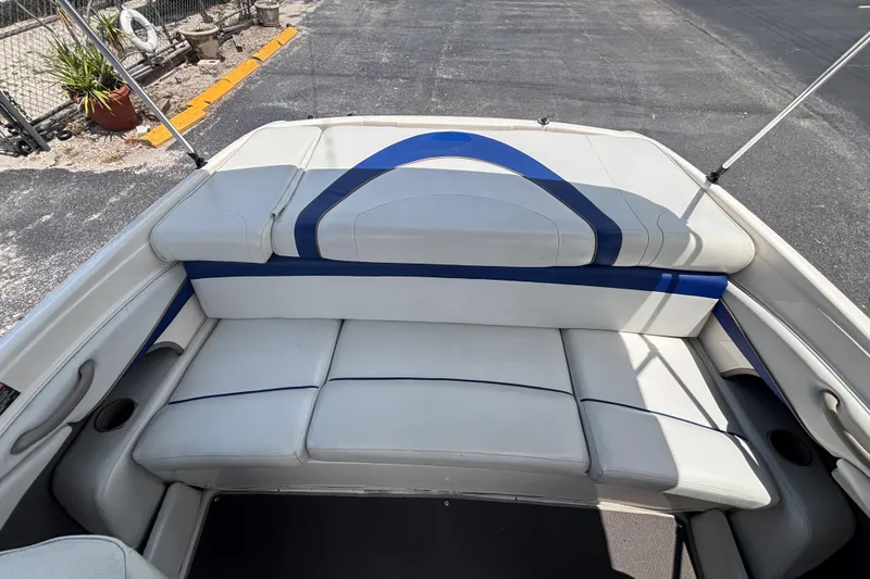 Slide: The Image of 2003 Bayliner 185 Capri boat interior with white and blue seating. - 24