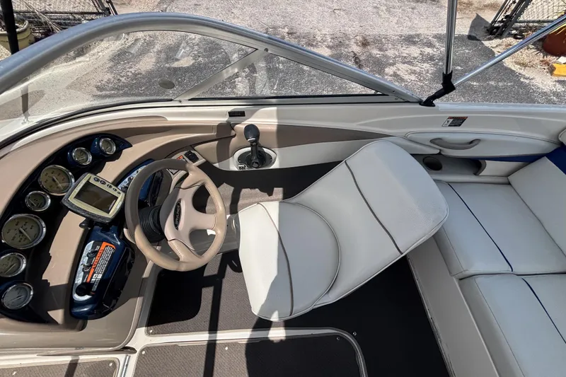 Slide: The Image of 2003 Bayliner 185 Capri boat interior with steering wheel, gauges, and seating. - 25