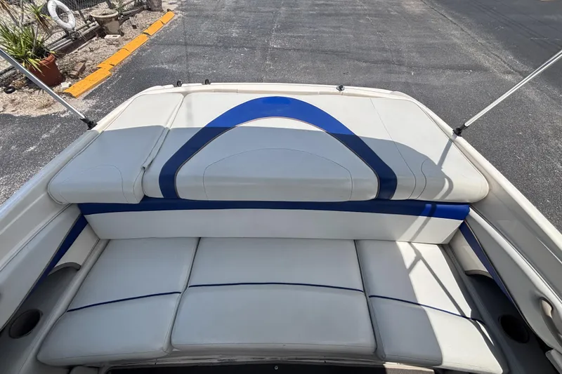 Slide: The Image of 2003 Bayliner 185 Capri boat interior with white and blue seating. - 27