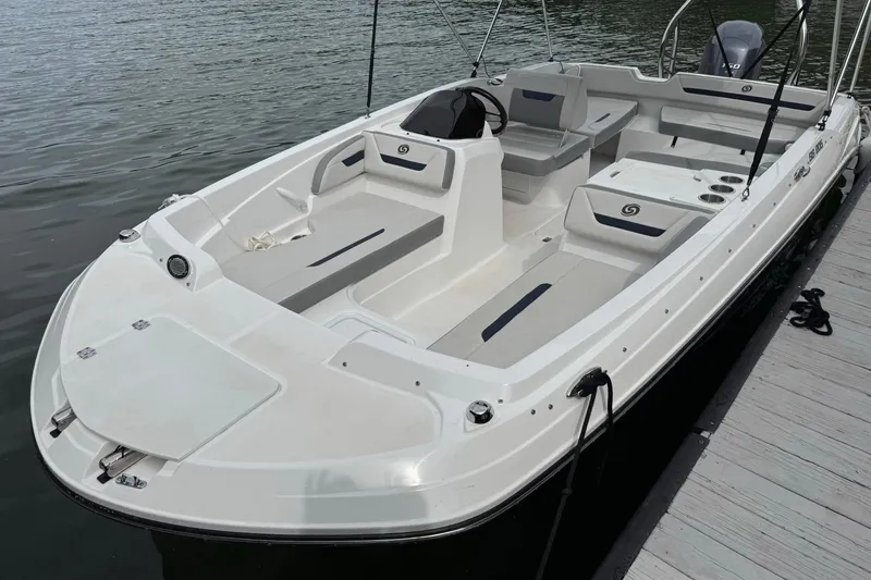 Slide: The Image of 2022 Hurricane SunDeck Sport 205 OB boat docked on calm water. - 1
