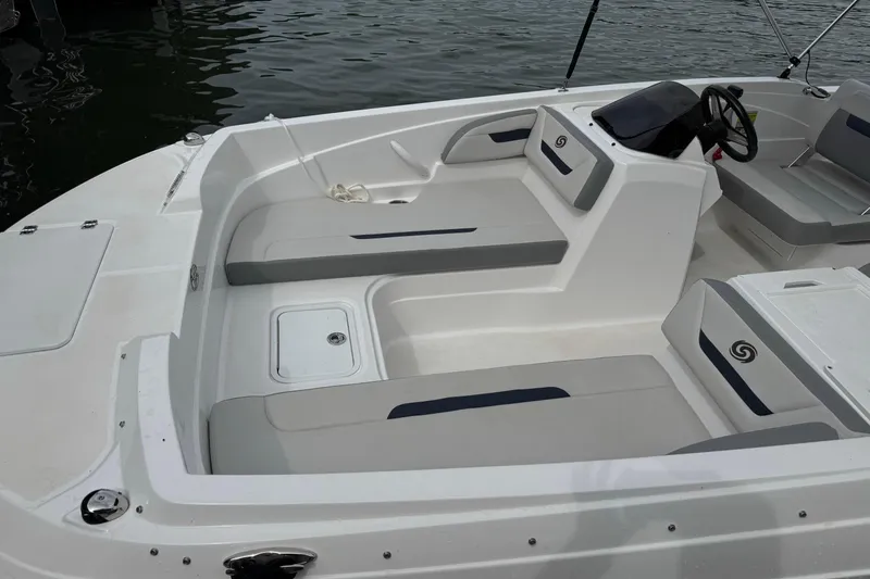 Slide: The Image of 2022 Hurricane SunDeck Sport 205 OB boat interior with seating and steering console. - 2
