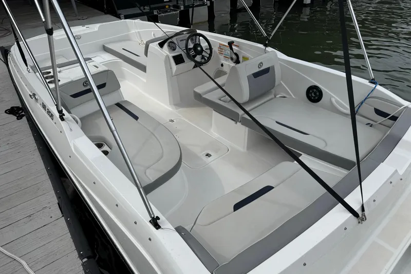Slide: The Image of 2022 Hurricane SunDeck Sport 205 OB boat interior with seating and steering wheel. - 3