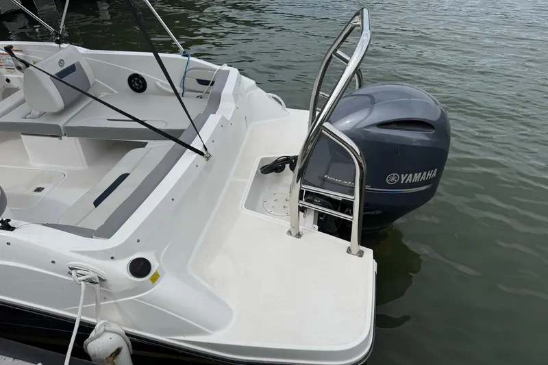 Slide: The Image of 2022 Hurricane SunDeck Sport 205 OB boat with Yamaha outboard motor, docked on water. - 4