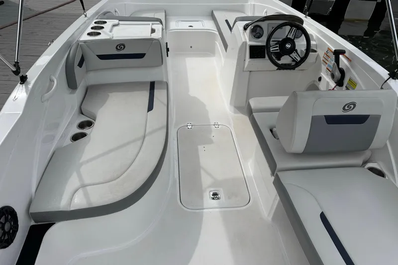 Slide: The Image of 2022 Hurricane SunDeck Sport 205 OB interior with seating, steering wheel, and cup holders. - 5