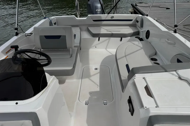 Slide: The Image of 2022 Hurricane SunDeck Sport 205 OB boat interior with seating and steering wheel. - 7