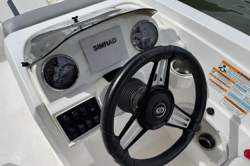 Slide: The Image of 2022 Hurricane SunDeck Sport 205 OB boat dashboard with steering wheel and gauges. - 8