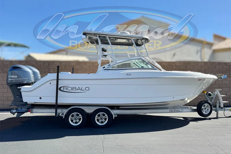 The Image of 2022 Robalo R247 Dual Console boat on trailer, featuring Yamaha engine. - 0