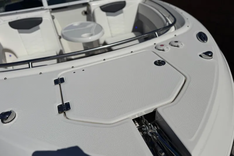 Slide: The Image of 2022 Robalo R247 Dual Console boat interior with seating and table. - 10