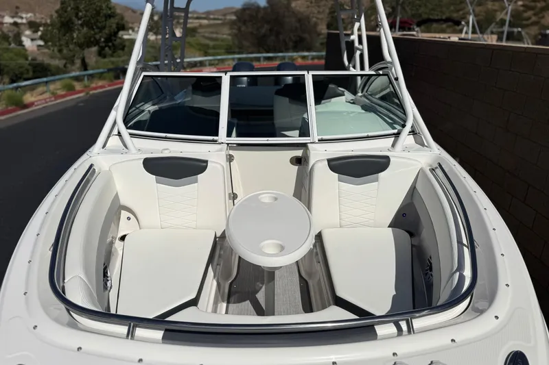 Slide: The Image of 2022 Robalo R247 Dual Console boat with spacious seating and table in the bow area. - 13