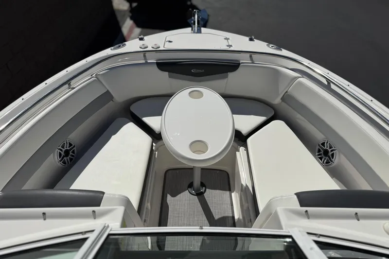 Slide: The Image of 2022 Robalo R247 Dual Console boat interior with seating and table setup. - 14