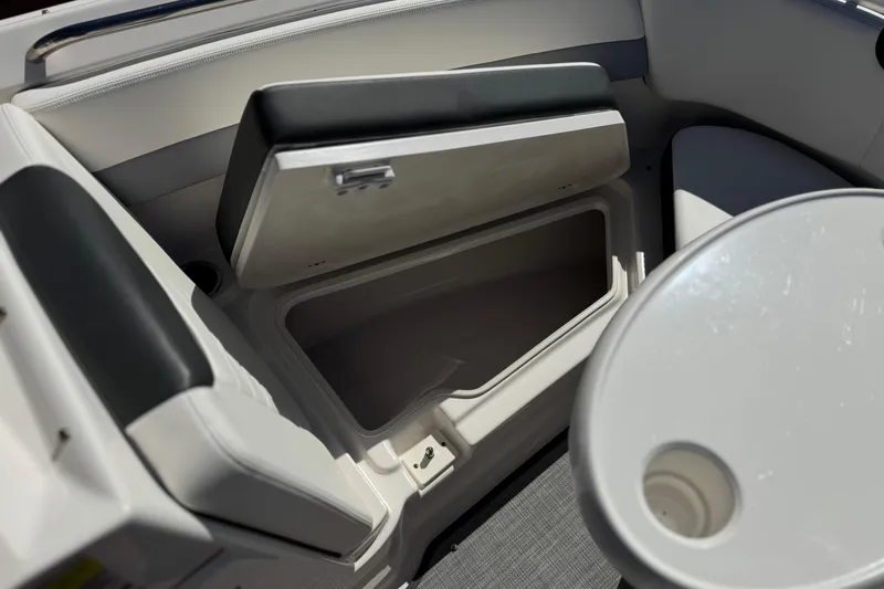 Slide: The Image of 2022 Robalo R247 Dual Console interior storage compartment and seating area. - 15