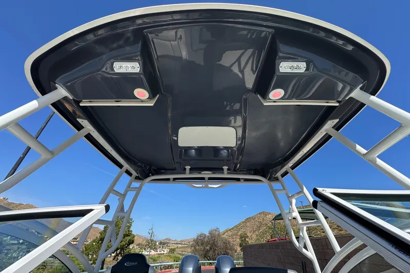 Slide: The Image of 2022 Robalo R247 Dual Console boat canopy against clear blue sky. - 17