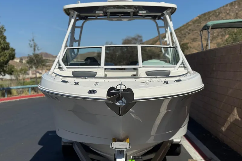 Slide: The Image of 2022 Robalo R247 Dual Console boat on trailer, parked outdoors. - 2