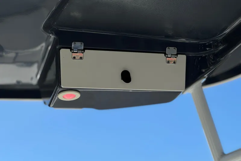 Slide: The Image of 2022 Robalo R247 Dual Console boat detail with sleek design against blue sky. - 20