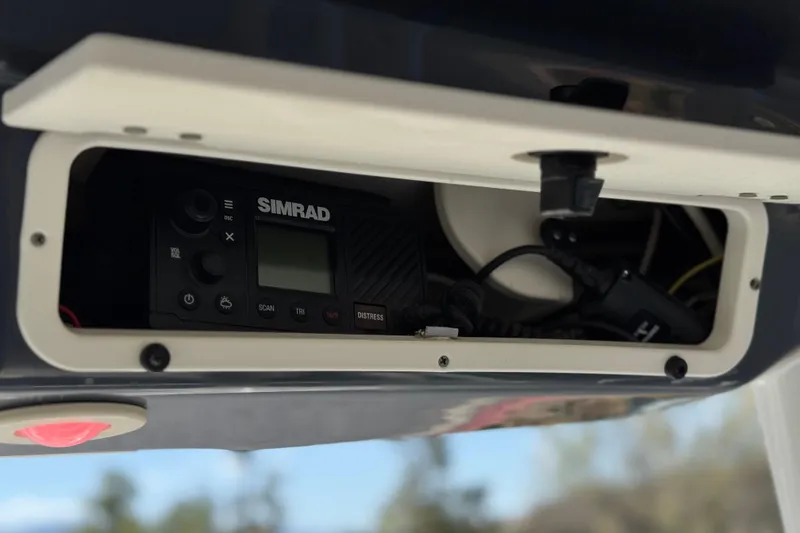 Slide: The Image of Simrad marine electronics in 2022 Robalo R247 Dual Console boat dashboard compartment. - 21