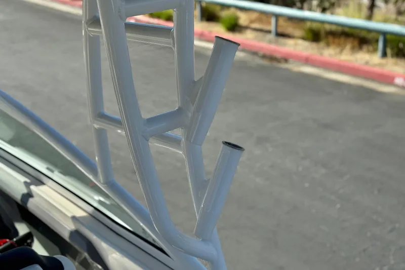 Slide: The Image of Close-up of 2022 Robalo R247 Dual Console boat's rod holders. - 22