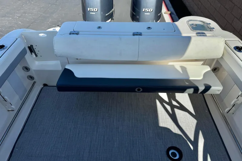 Slide: The Image of 2022 Robalo R247 Dual Console boat interior with seating and Yamaha 150 engine. - 25