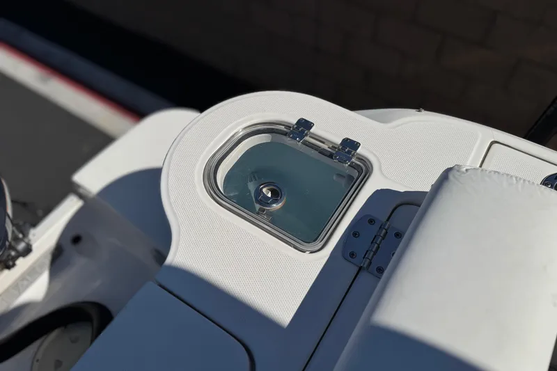 Slide: The Image of 2022 Robalo R247 Dual Console boat detail with storage compartment and cushioned seating. - 31