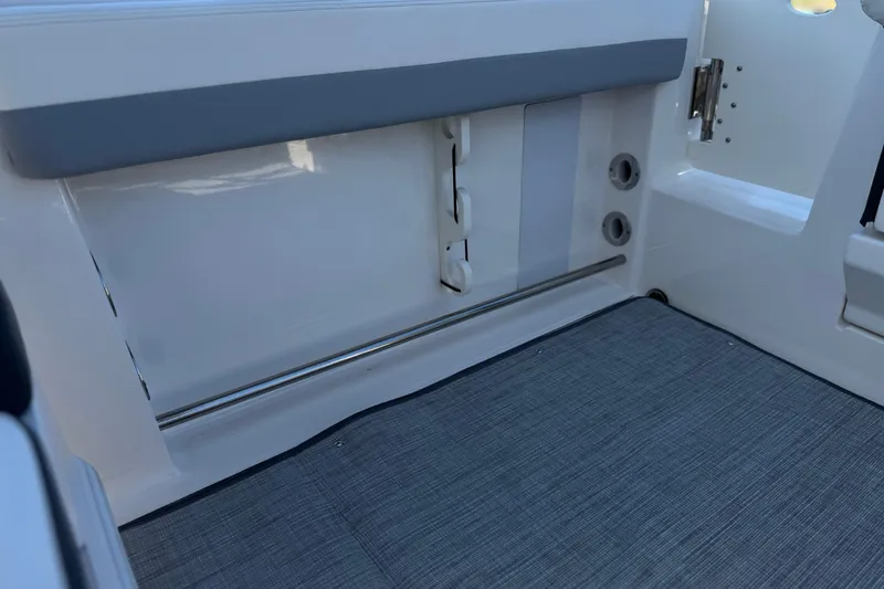 Slide: The Image of 2022 Robalo R247 Dual Console interior detail with gray flooring and white paneling. - 33