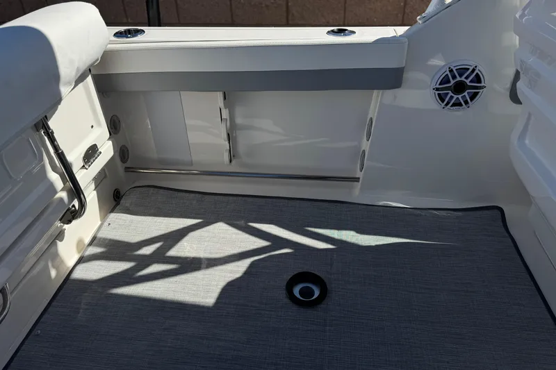 Slide: The Image of 2022 Robalo R247 Dual Console boat interior with seating and speaker detail. - 34