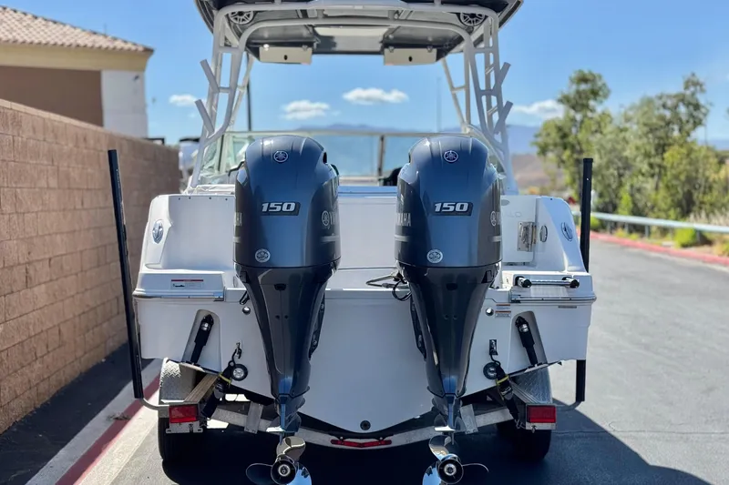 Slide: The Image of 2022 Robalo R247 Dual Console boat with twin Yamaha 150 engines. - 4