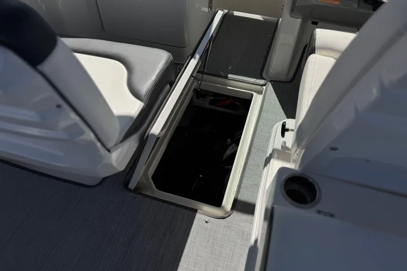 Slide: The Image of 2022 Robalo R247 Dual Console boat interior with open storage compartment. - 40