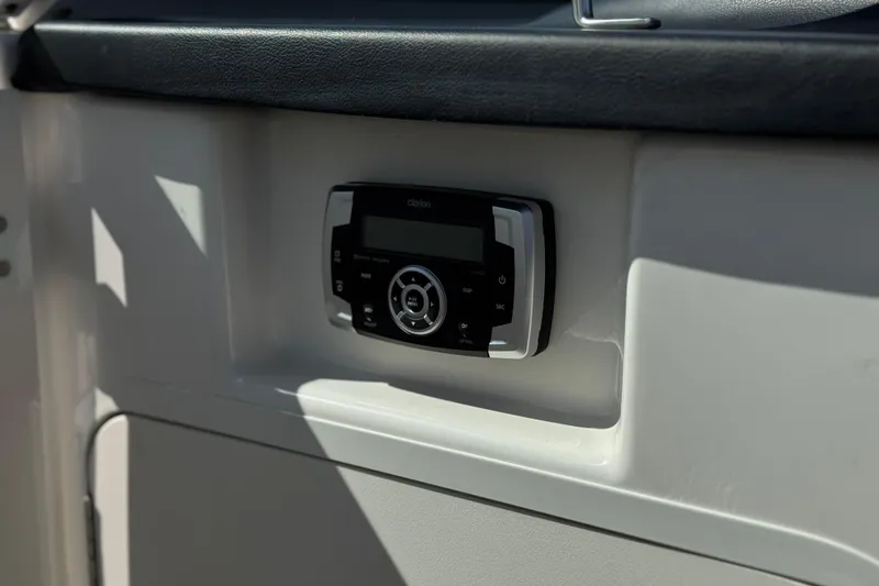 Slide: The Image of 2022 Robalo R247 Dual Console boat stereo system, featuring a sleek Clarion audio unit. - 44