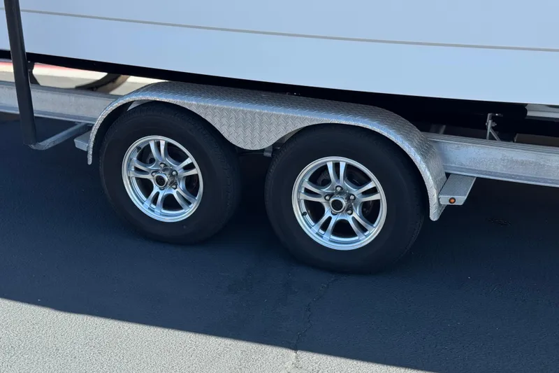 Slide: The Image of Trailer wheels of a 2022 Robalo R247 Dual Console boat. - 47