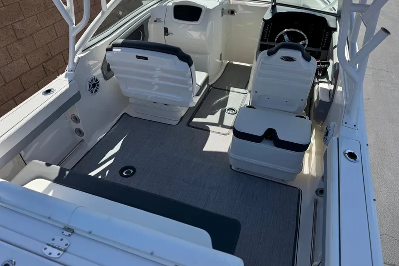 Slide: The Image of 2022 Robalo R247 Dual Console boat interior with seating and steering wheel. - 9