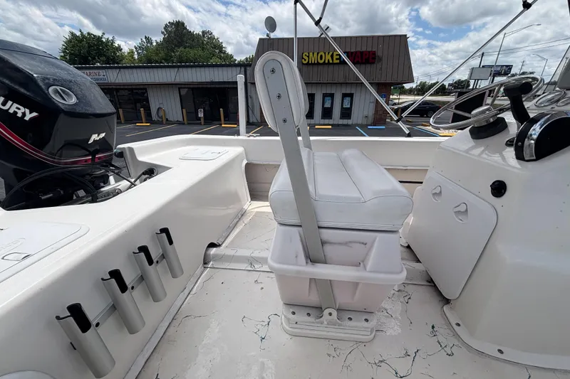 Slide: The Image of 2008 Sundance B18CC boat interior with Mercury engine, rod holders, and steering console. - 14