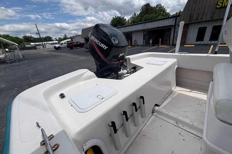 Slide: The Image of Sundance B18CC 2008 boat with Mercury outboard motor in a parking lot. - 15