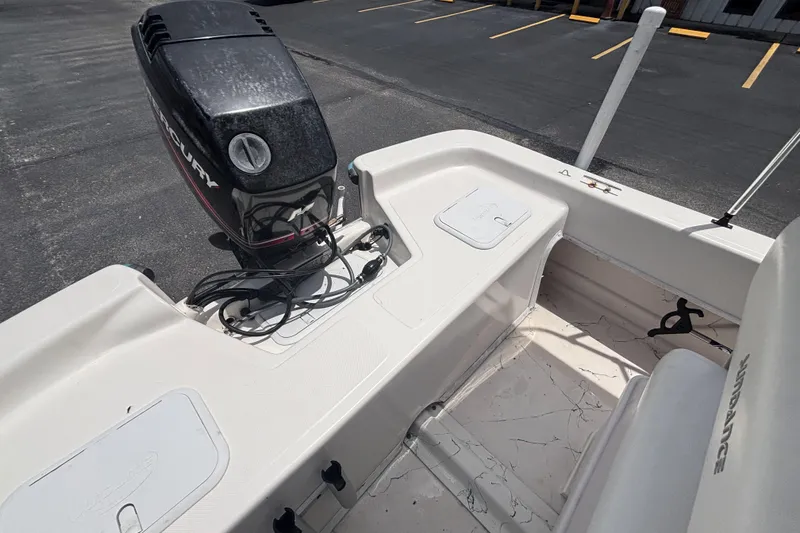 Slide: The Image of 2008 Sundance B18CC boat with Mercury outboard motor, parked in a lot. - 22