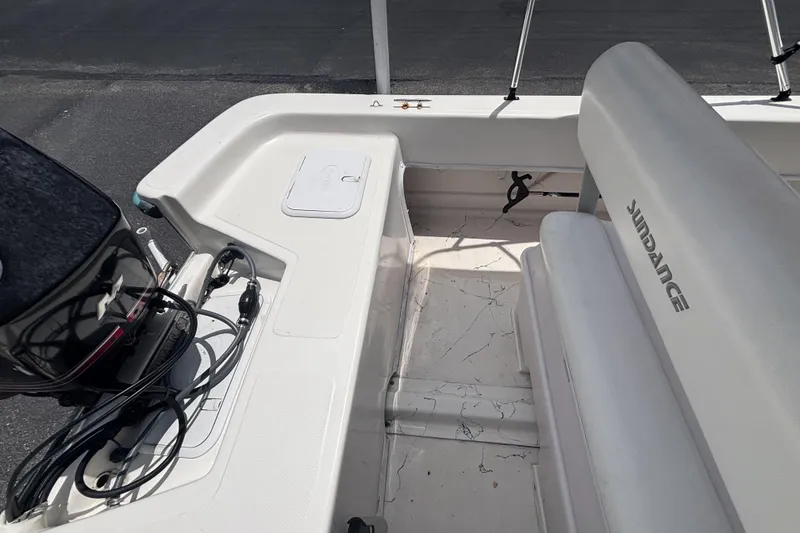 Slide: The Image of 2008 Sundance B18CC boat interior with seating and motor cables visible. - 23