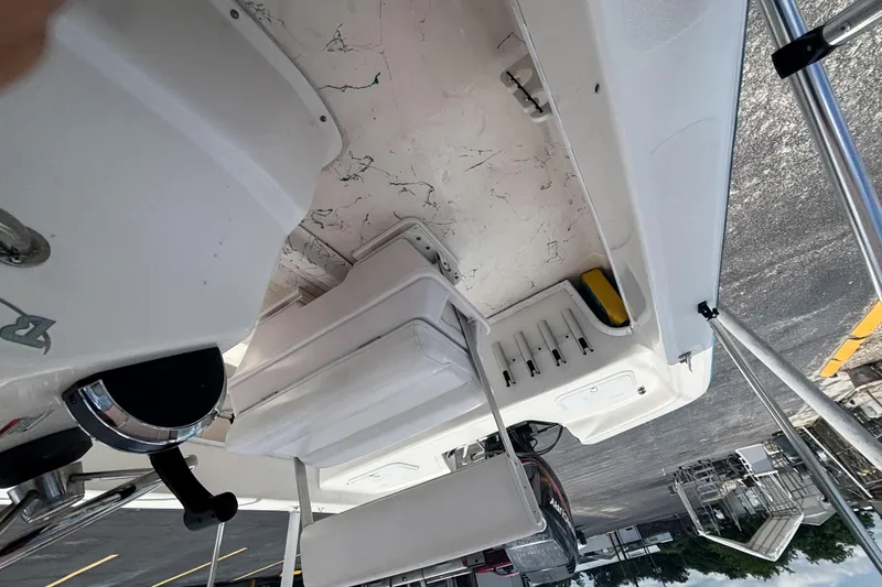 Slide: The Image of Interior view of a 2008 Sundance B18CC boat, showcasing seating and storage compartments. - 29
