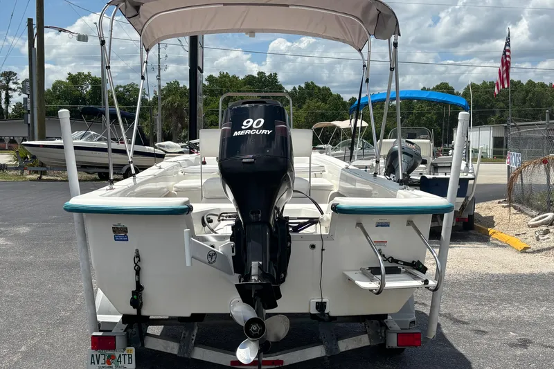 Slide: The Image of 2008 Sundance B18CC boat with Mercury 90 engine on trailer, outdoor setting. - 3