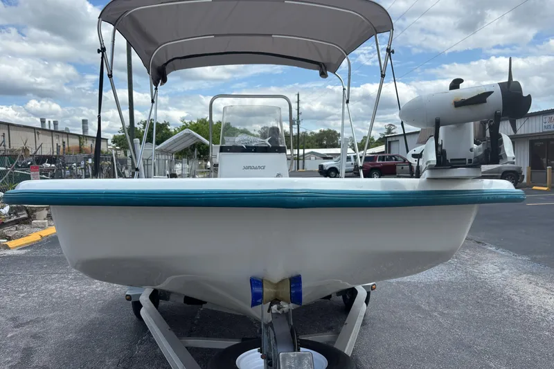 Slide: The Image of 2008 Sundance B18CC boat with canopy and motor, parked outdoors on a trailer. - 7