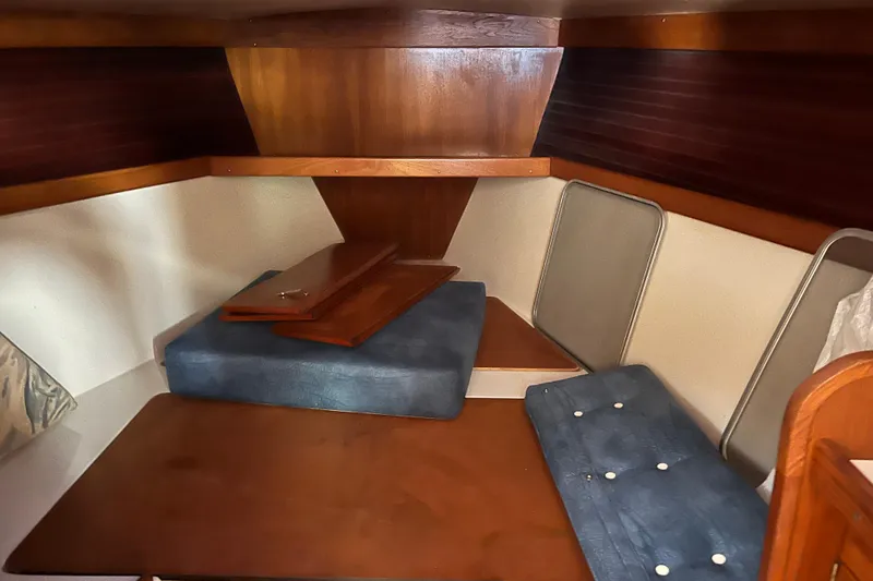 Slide: The Image of Interior cabin of a 1999 Catalina 36 MkII sailboat with wooden and cushioned seating. - 10